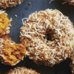 Baked pumpkin donuts with glaze and coconut.
