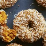 Baked pumpkin donuts with glaze and coconut.