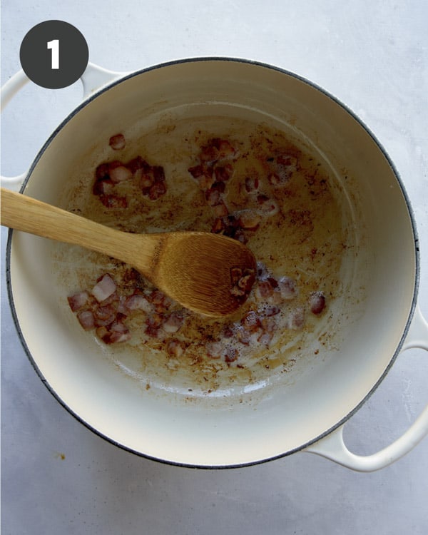 Crisping up bacon in a pot to make clam chowder.