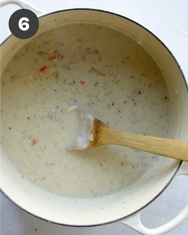 Clam chowder in a pot with milk added to make it creamy.