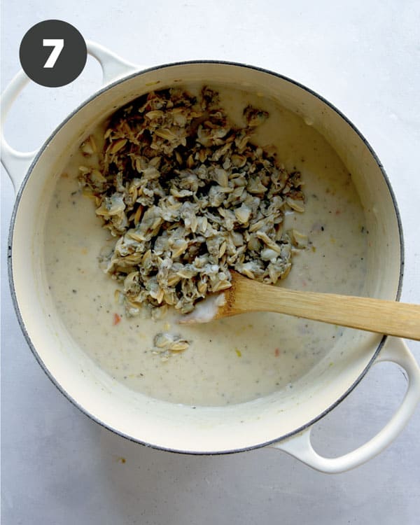 Clams being added to a pot to make clam chowder recipe.