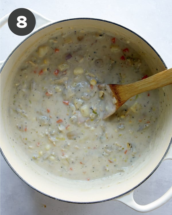 Clam chowder in a pot simmering to make it thick.