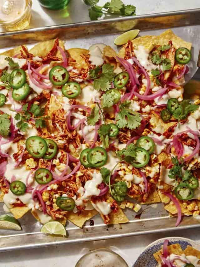 chipotle chicken nachos on a baking sheets on a table