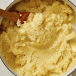 Mashed potatoes mixed together in a pot.