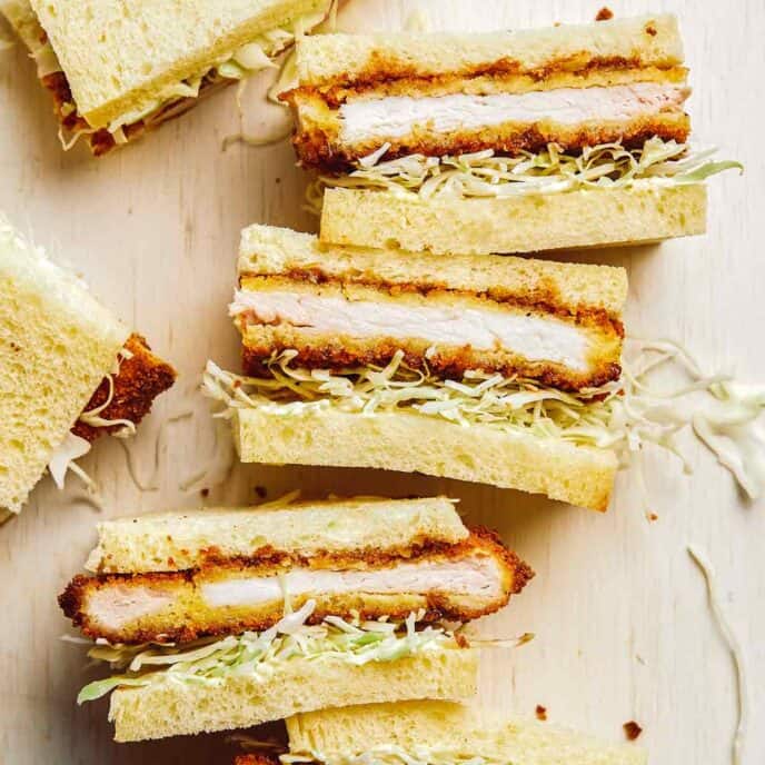 Stacked pork katsu sandwiches cut in half.