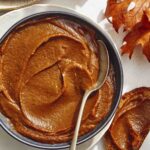 Pumpkin butter in a bowl with pieces of toast.