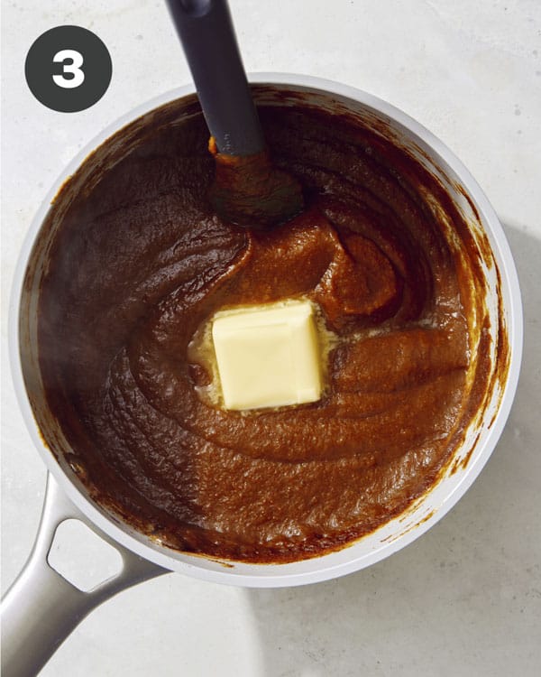 Pumpkin butter in a pot with butter melting in it. 