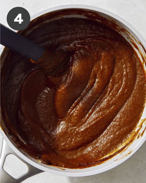 Pumpkin butter in a pot simmering.