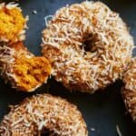 Baked pumpkin donuts with glaze and coconut.