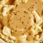 Roasted garlic gravy recipe on mashed potatoes.