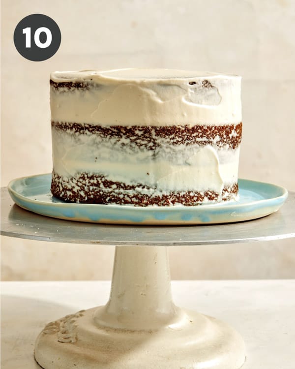 Smash layer cake being crumb coated.