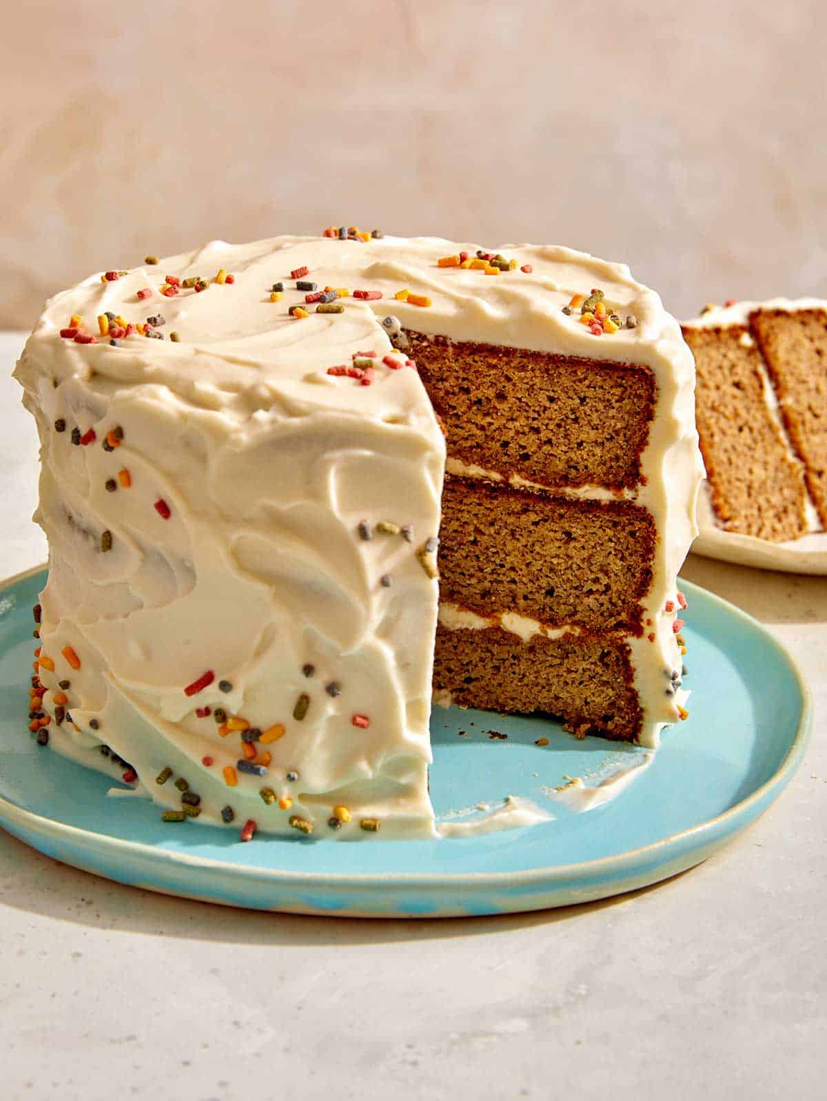 Banana date smash cake recipe with a slice taken out of it.