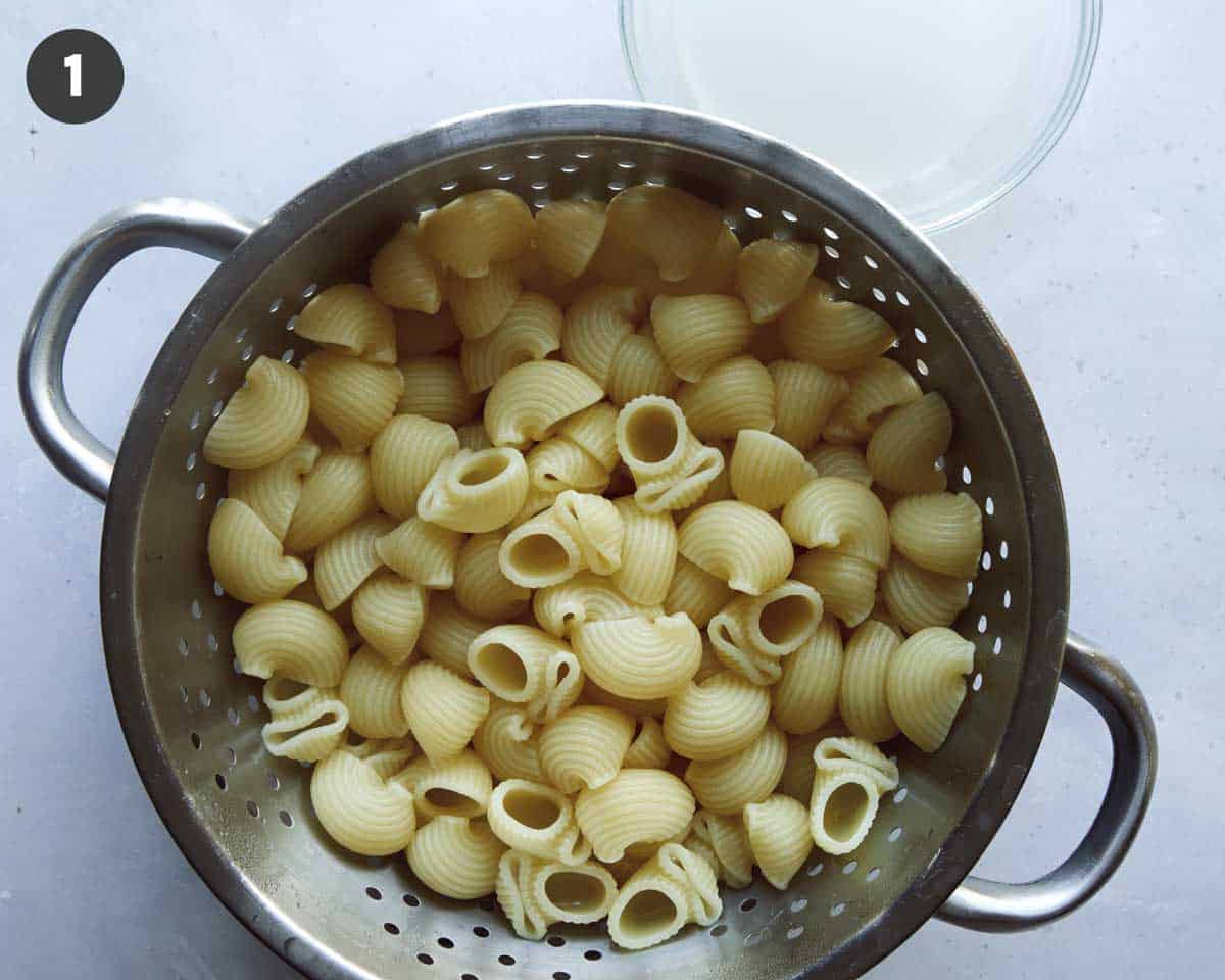 Pasta for stovetop mac and cheese in a colander drained.