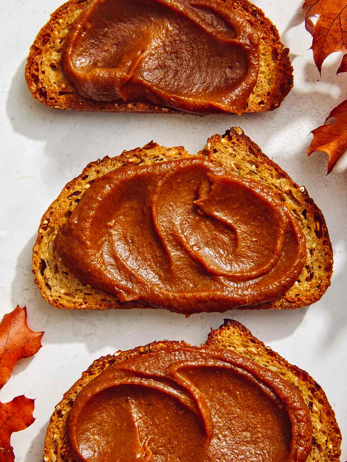 Pumpkin butter smeared on pieces of toast. 