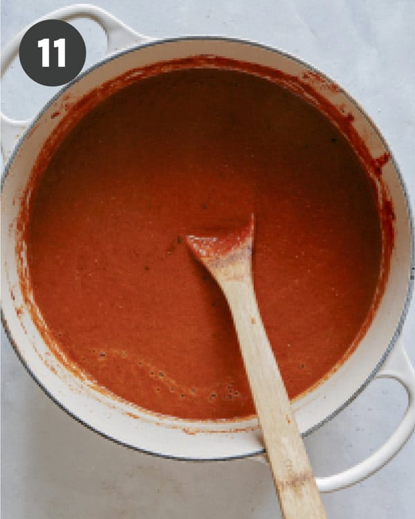 Tomato soup simmering in a stock pot.