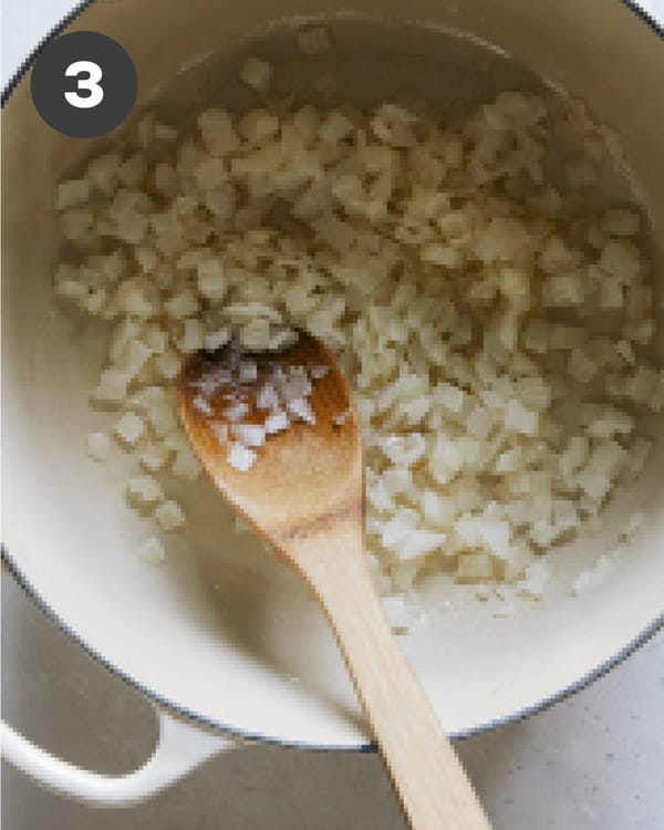 Onions cooking in a pot to make tomato soup.