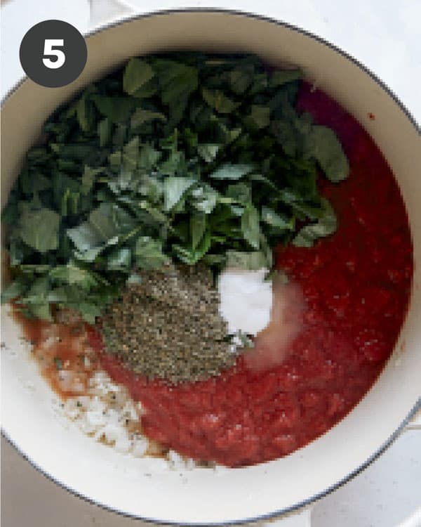 Tomato soup with basil in a pot.