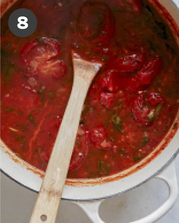 Tomato soup simmering in a stock pot.