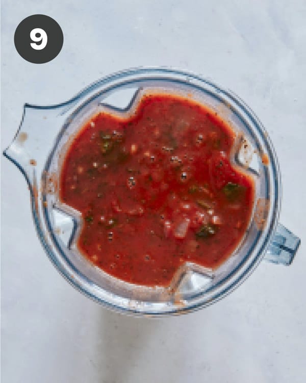 Tomato soup in a blender about to be blended.