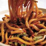 Yaki udon noodle recipe in a bowl with chopsticks.