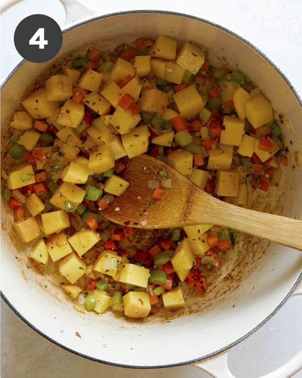 Vegetables cooking in a pot to make zuppa toscana. 