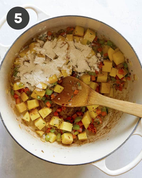 Flour with veggies in a pot to make Zuppa Toscana recipe. 