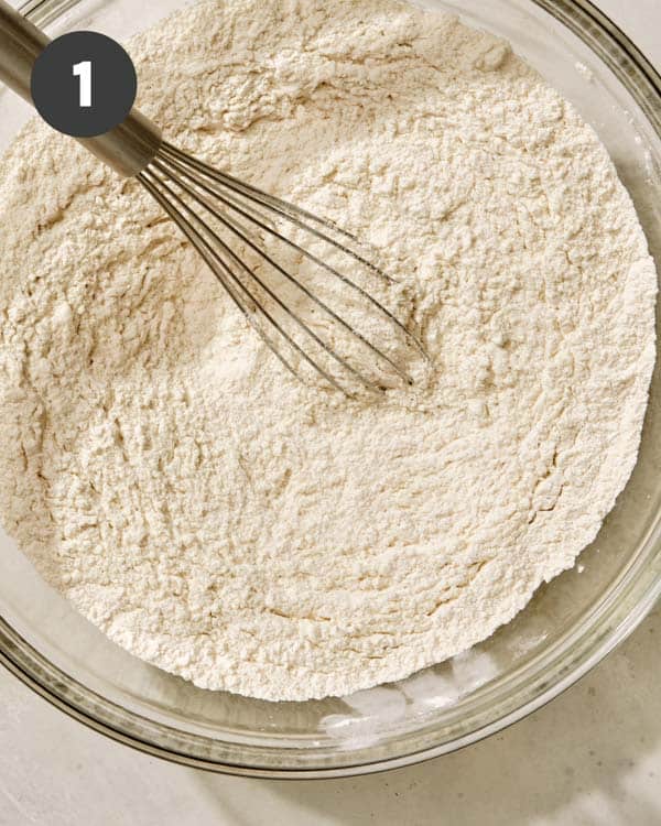 Buttermilk biscuit dry ingredients in a bowl with a whisk. 