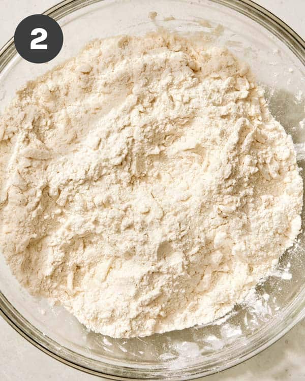 Cutting in butter in a buttermilk biscuit dough.