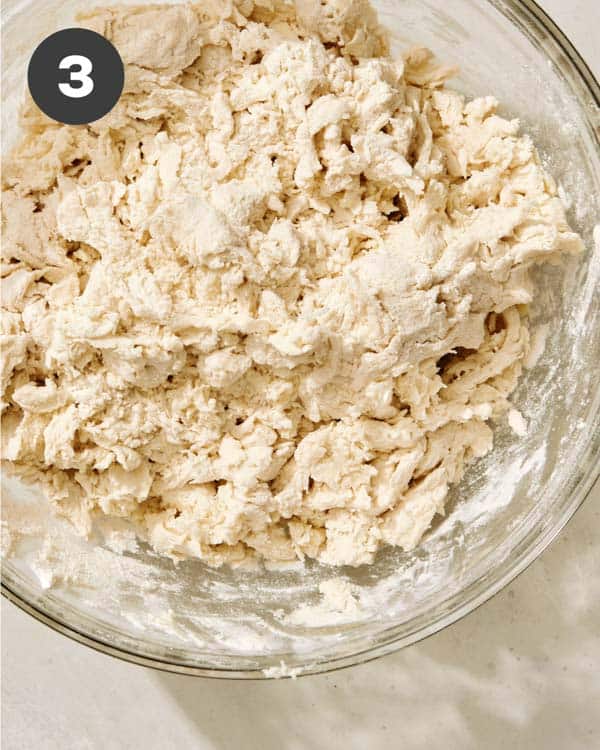 Buttermilk biscuit dough in a glass bowl.