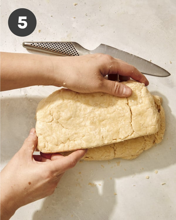 Buttermilk biscuit dough cut in half and placed on top of one another. 