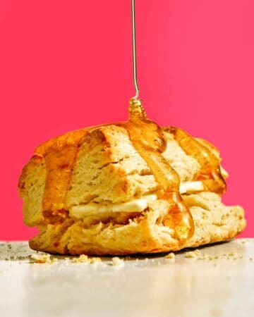 Homemade buttermilk biscuit recipe with honey on top.