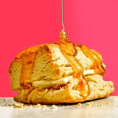 Homemade buttermilk biscuit recipe with honey on top.