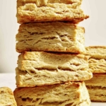 A stack of buttermilk biscuits in a kitchen.