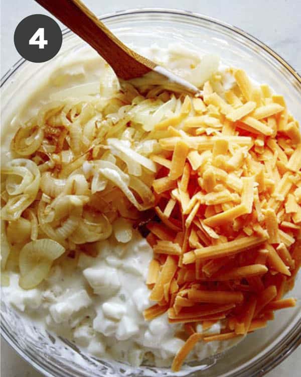 Cheesy potato casserole ingredients in a bowl.