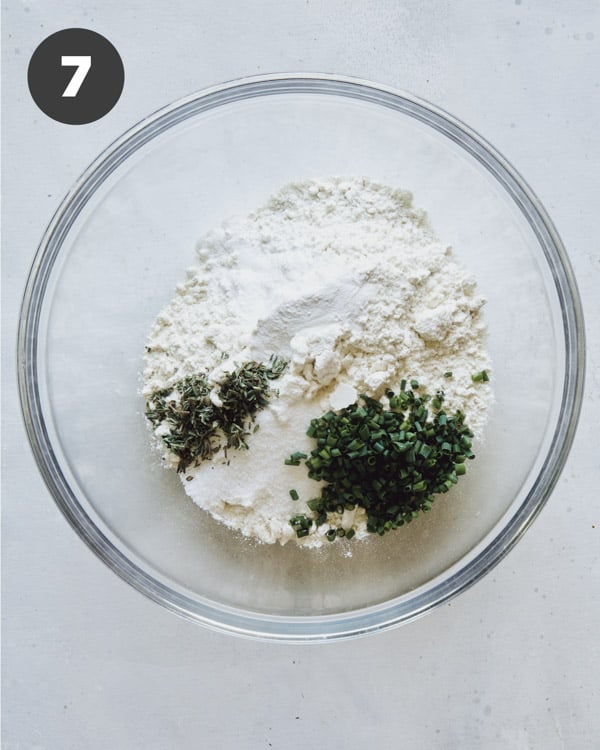 Dry ingredients for dumplings in a glass bowl.