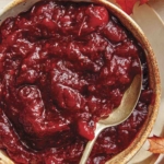 Cranberry sauce recipe in a bowl with a spoon.