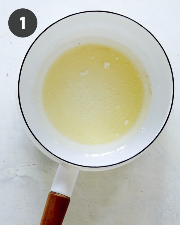 Melted butter in a skillet on a kitchen counter.