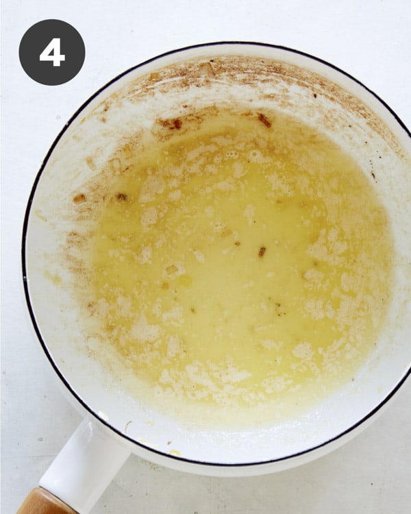 Melted butter in a skillet on a kitchen counter.