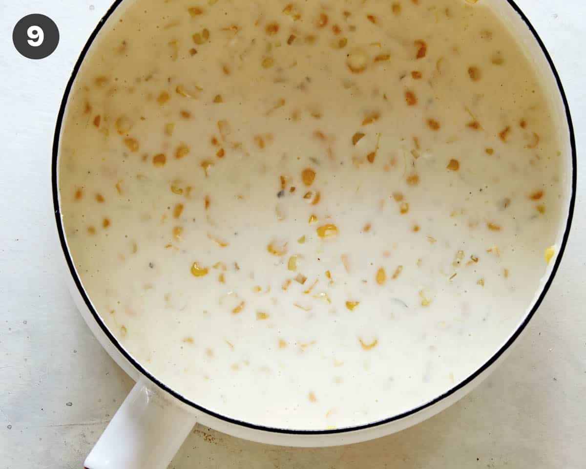 Creamed corn simmering in a skillet.