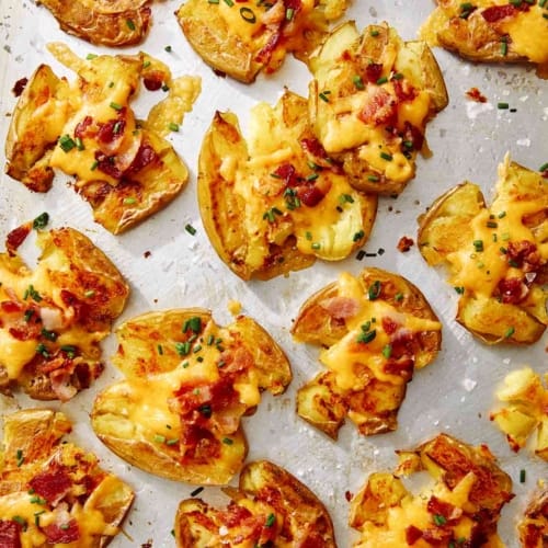 Close up on smashed potatoes on a platter.