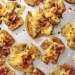 Close up on smashed potatoes on a platter.