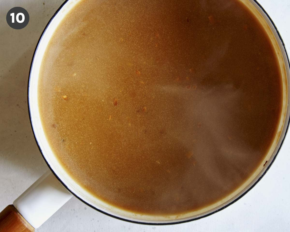 Roast beef gravy in a pot.