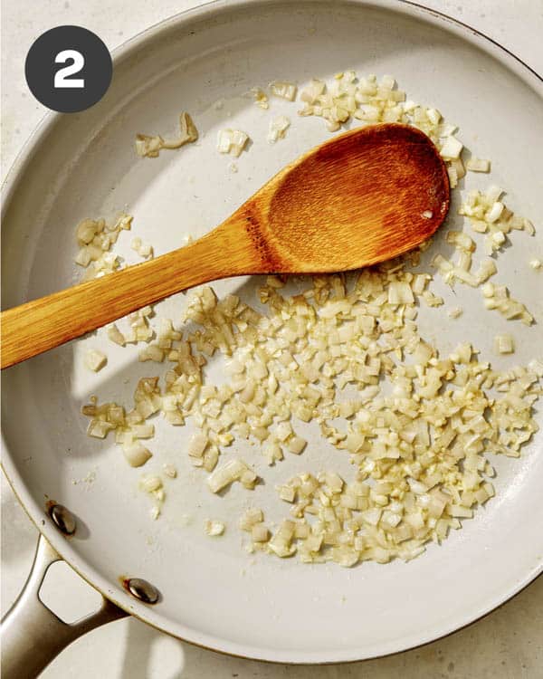 Shallots cooking in a skillet with butter. 