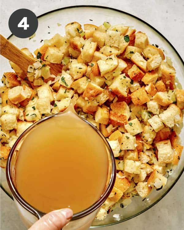 Stock being poured into a bowl with stuffing. 