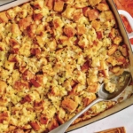 Stuffing in a baking dish with a scoop taken out.