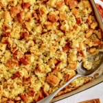 Stuffing in a baking dish with a scoop taken out.