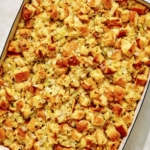 Stuffing in a baking dish with a scoop taken out.