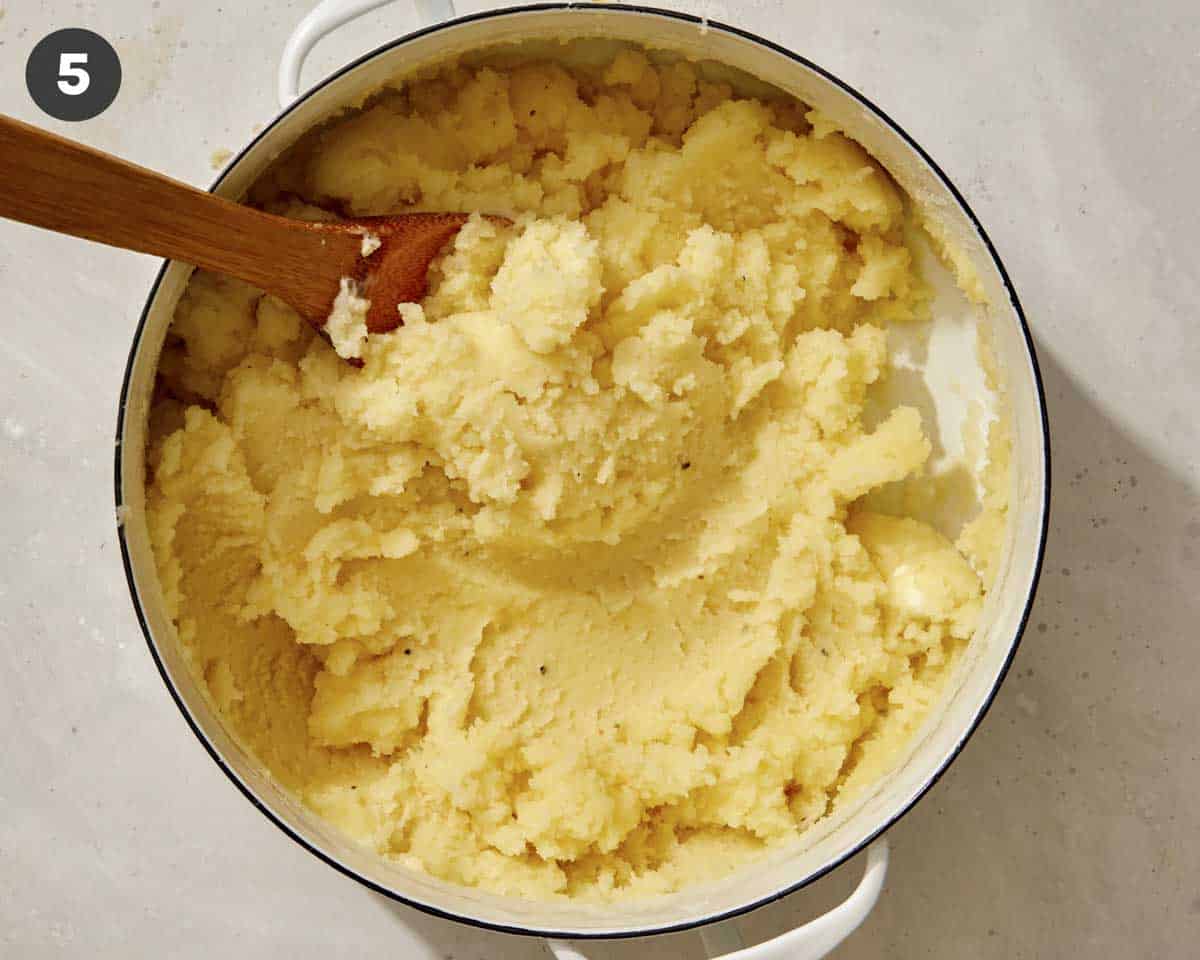 Mashed potatoes mixed together in a pot.
