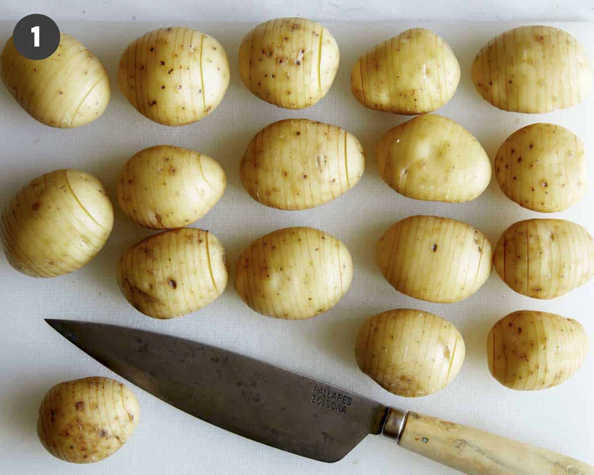 Slicing potatoes to make a hasselback potato recipe.