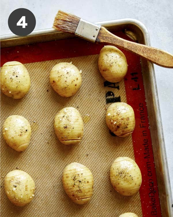 Basing hasselback potatoes with butter.